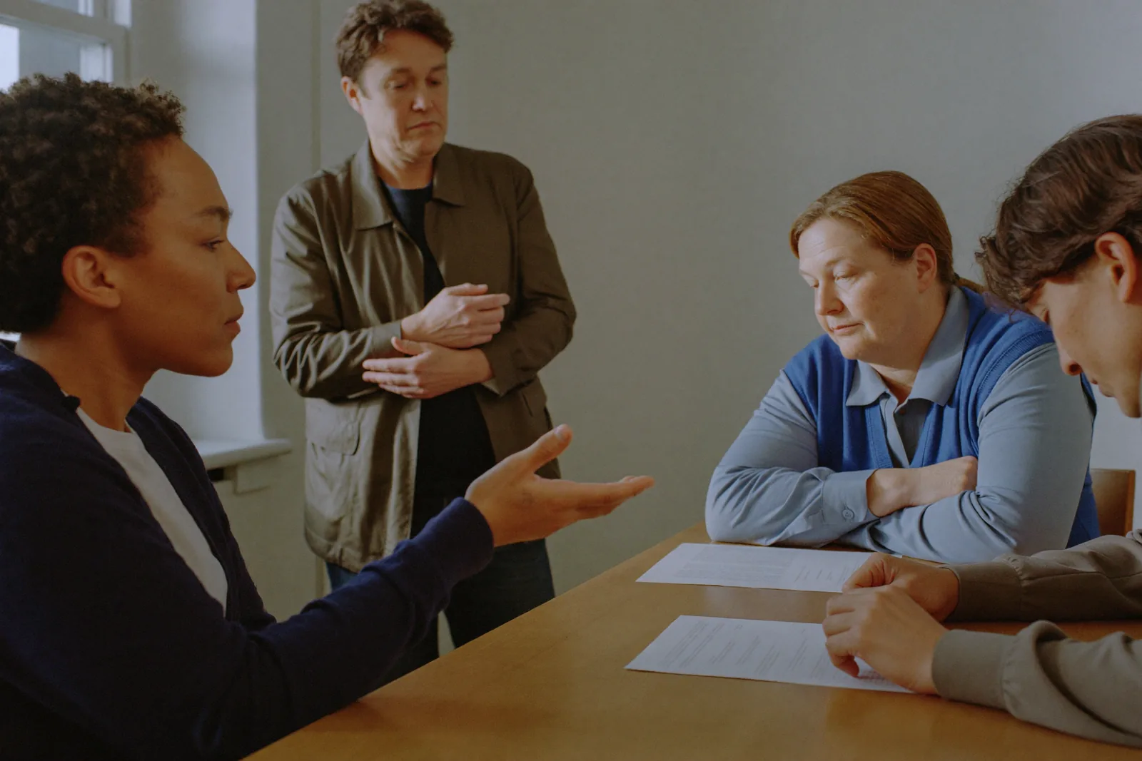 Professionals taking part in a small-group training discussion around a table.